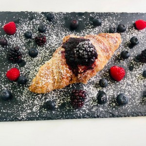 Croissant with butter, jam and  fresh fruit